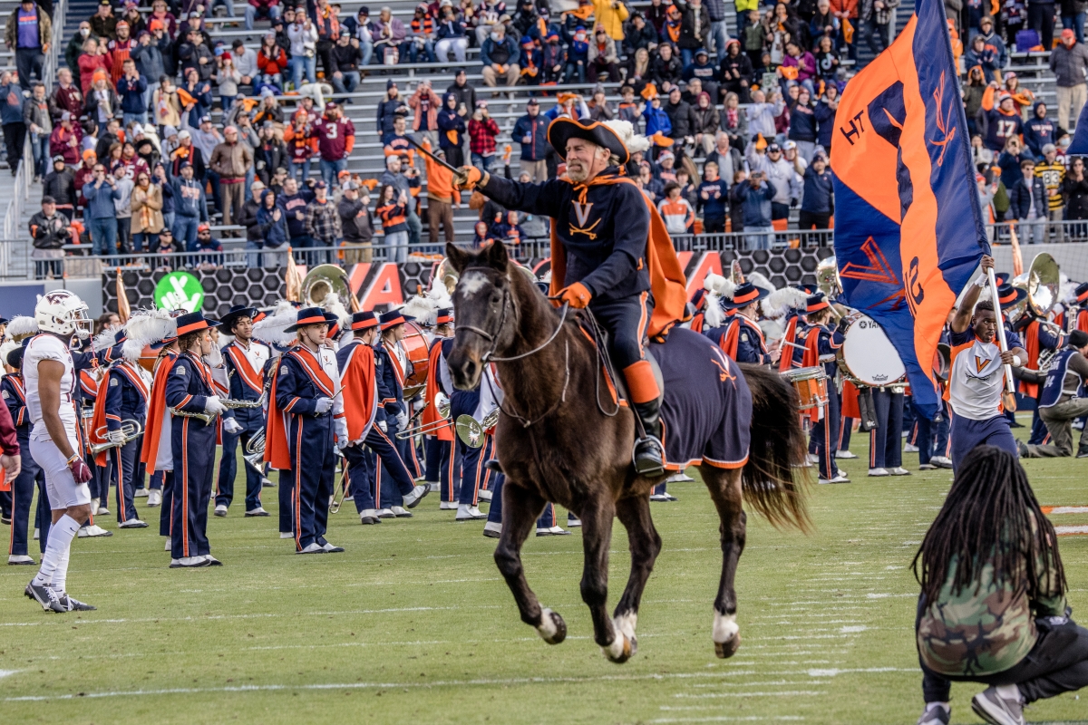 Cav Man storming through Scott Stadium with CMB members cheering after the pregame show.
