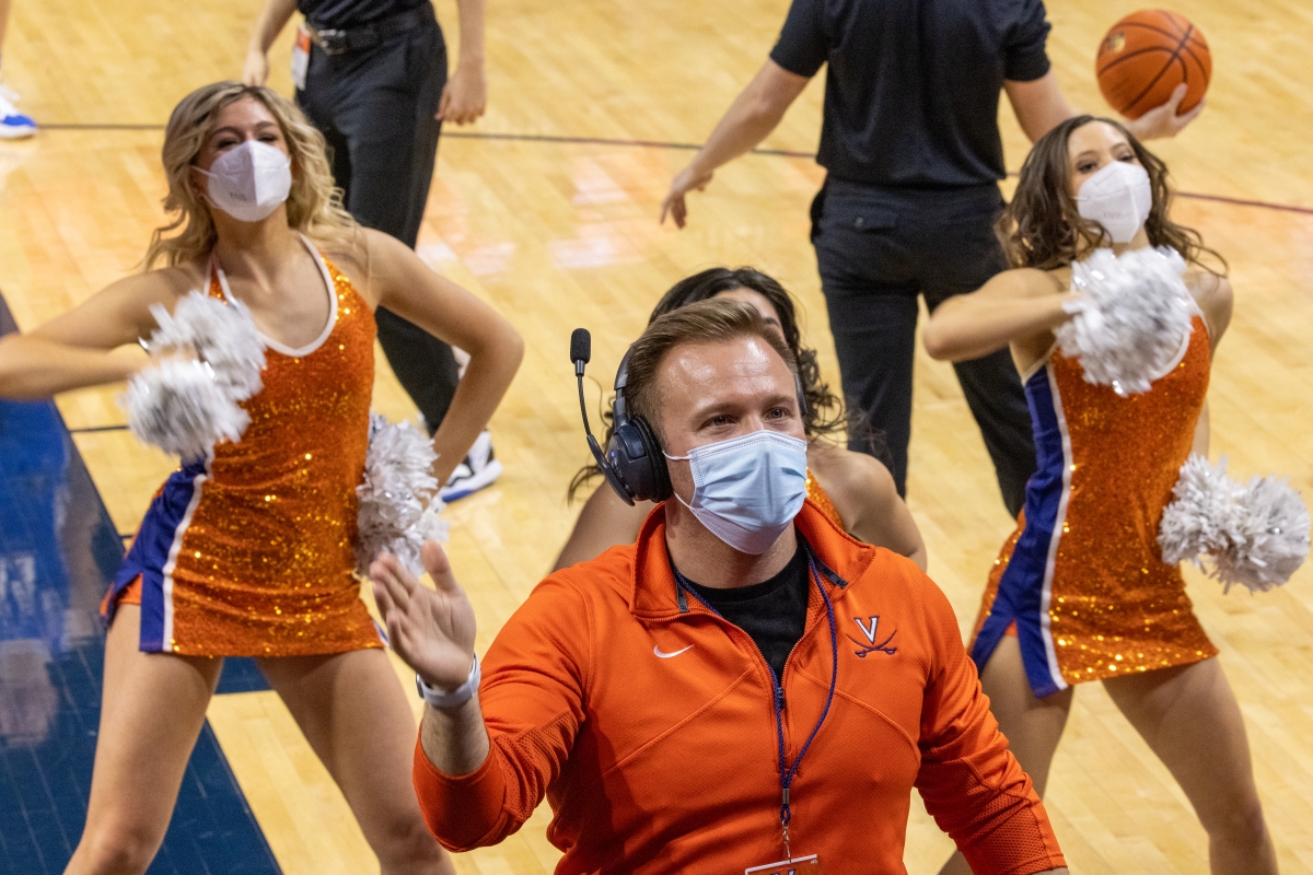 Dr. Tackitt conducting the HOOps Band as the UVA Dance Team breaks it down in the background.​